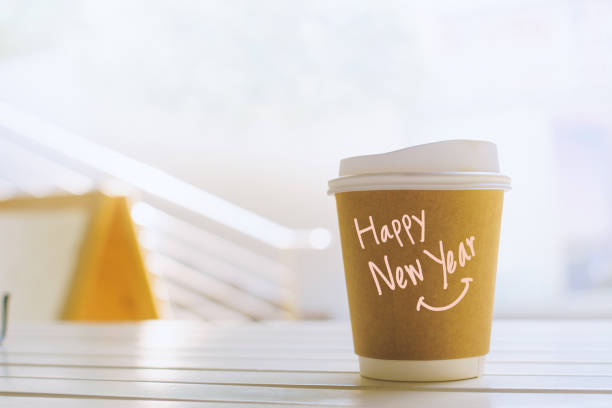 istock Happy New Year. Handwritten message on recycled paper coffee cup. A fresh start for the environment. 1625621237