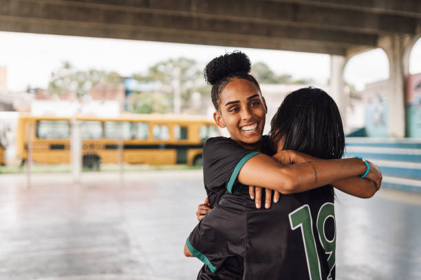 istock Female futsal players hugging celebrating 1625624070