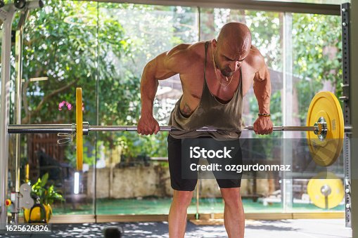 istock Young athlete man exercising with barbell in the gym 1625626826