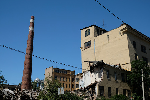 ruined old factory building with brick chimney