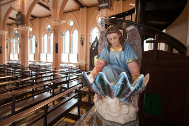 Virgin Blessed Mary statue with wing read bible book inside Roman Catholic Church at Chanthaburi, Thailand