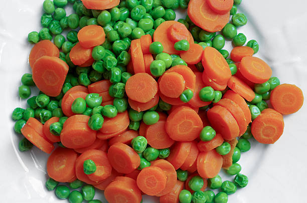 istock green peas and carrots 162573448