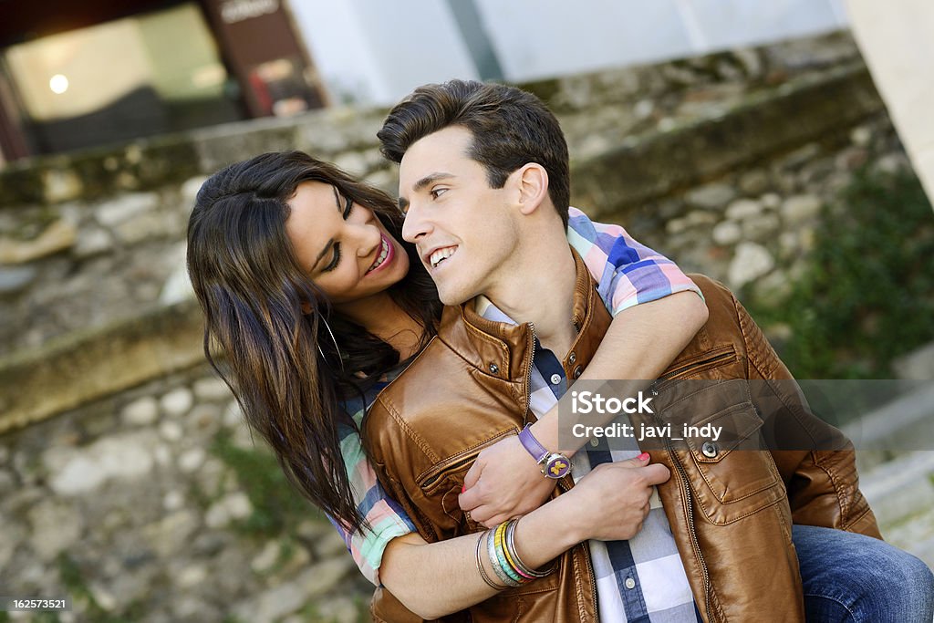 Cheerful young couple on a city street Portrait of a cheerful young couple on a city street Adult Stock Photo