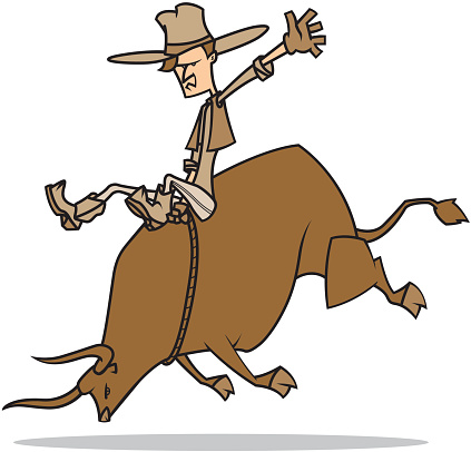 A cowboy riding a bucking bull