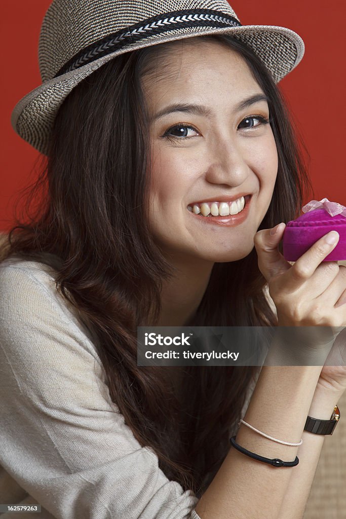 beautiful asian women with ringbox beautiful asian young lady is holding a ring box in her hand, she's just got from her boyfriend. 20-29 Years Stock Photo