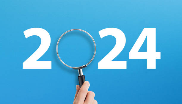 Happy New Year 2024 with magnifying glass on blue background
