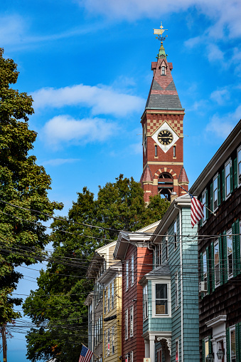 The clock tower of Abbot Hall, Marblehead's town hall, looms above nearby houses.