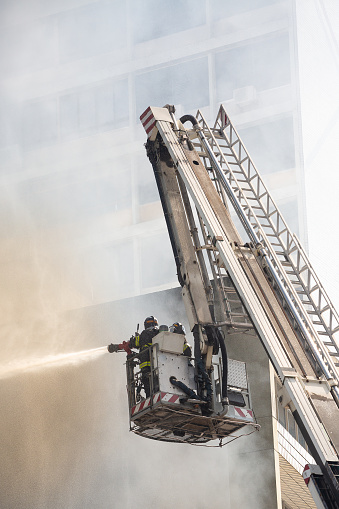 Santos, Brazil. September 26, 2015. Firemen putting out fire with water jet equipment.