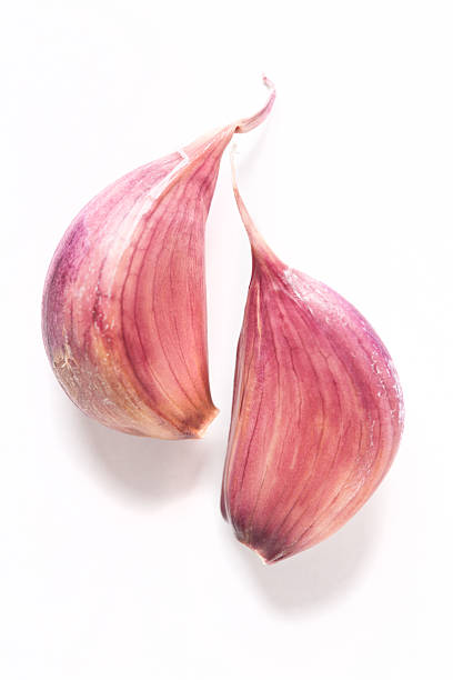 garlic cloves two garlic cloves on white background garlic clove photos stock pictures, royalty-free photos & images