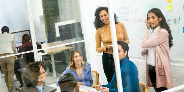 istock Female latin company managers using brainstorming technique in conference room 1625842887