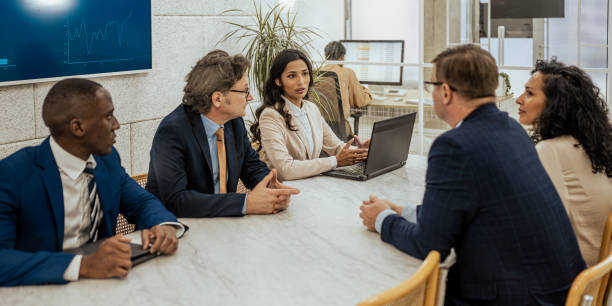 istock Multiracial business partners sitting at conference table, medium shot 1625842903
