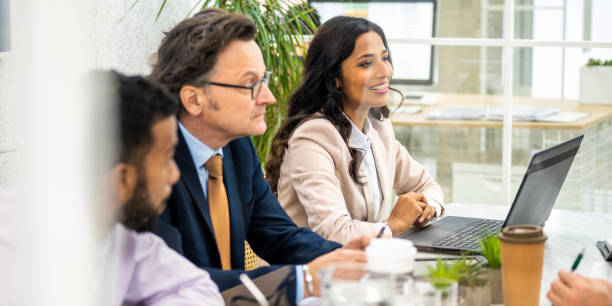 istock Diverse business partners sitting in conference room 1625843416