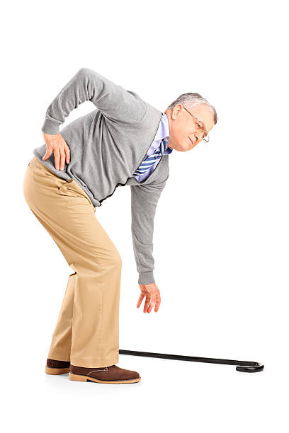 Senior man with pain trying to pick up a cane