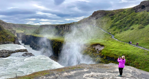 istock Woman taking photos at Iceland waterfall (Gulifoss) 1625852895