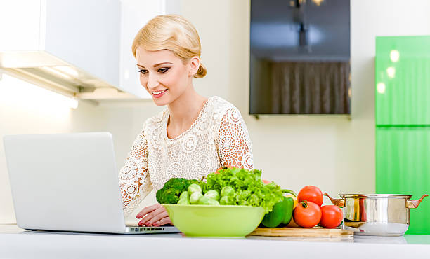 istock Woman looking for a recipe on the laptop computer 162586166