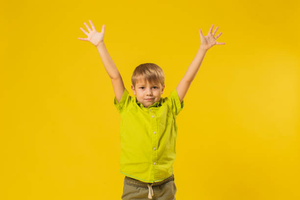 istock Boy in shirt in studio on yellow background 1625865041