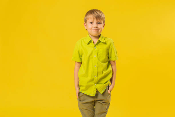 istock Boy in shirt in studio on yellow background 1625866707