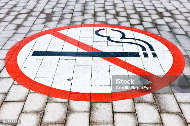 Señal De Prohibido Fumar Pintado En Ladrillo Empedrado Piso Foto de stock y más banco de imágenes de Adicción
