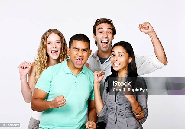 Four Excited Friends Cheering Something Or Someone On Stock Photo - Download Image Now