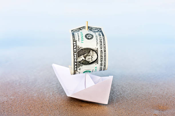 istock Paper boat with $1 sail runs aground:  financial problems ahead 162586928