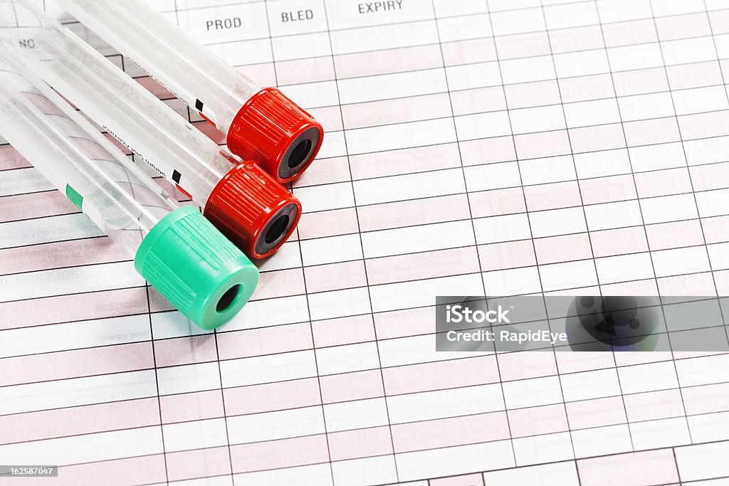 Blood collection tubes in varied colors on blank medical form Blood collection tubes in various colors rest on a blank medical form used for ordering blood  tests from a pathology laboratory. Airtight Stock Photo