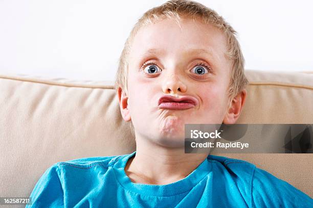 Cute 8 Year Old Blond Boy Pulls A Funny Face Stock Photo - Download Image Now - 8-9 Years, Activity, Beautiful People