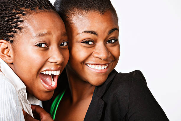 istock Two beautiful young women friends laugh together 162587328