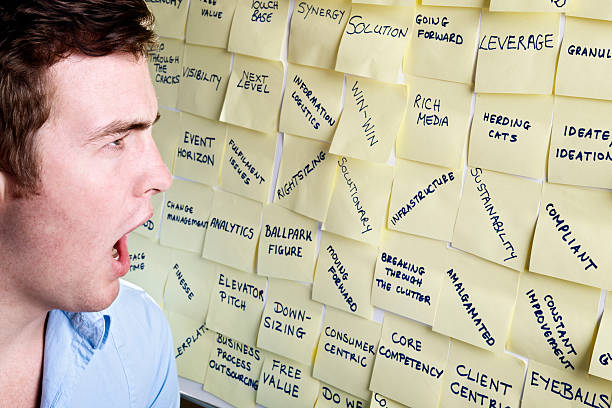 istock Shocked young man gapes at noticeboard covered with buzzwords 162587512