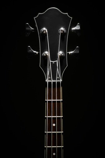 Head stock of a dark electrical bass guitar