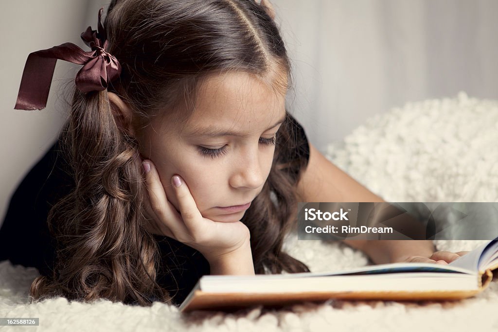 Beautiful girl reading book, indoor Book Stock Photo