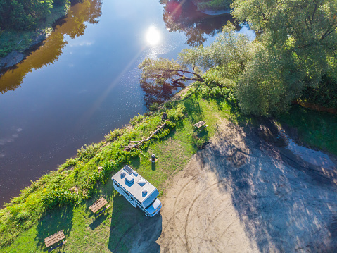 Aerial view of motor home with river during summer day