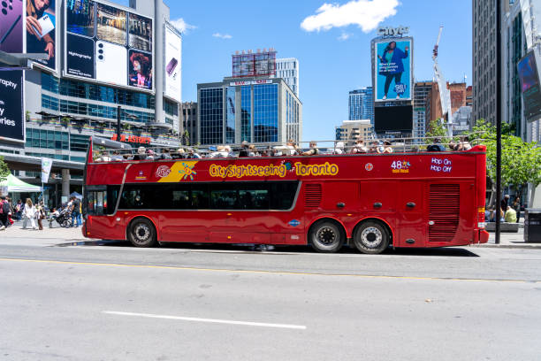 A tour bus at Yonge-Dundas Square in Toronto. Toronto, ON, Canada - June 4, 2022: A tour bus at Yonge-Dundas Square in Toronto. Yonge–Dundas Square, or Dundas Square, is a public square in downtown Toronto. toronto dundas square stock pictures, royalty-free photos & images
