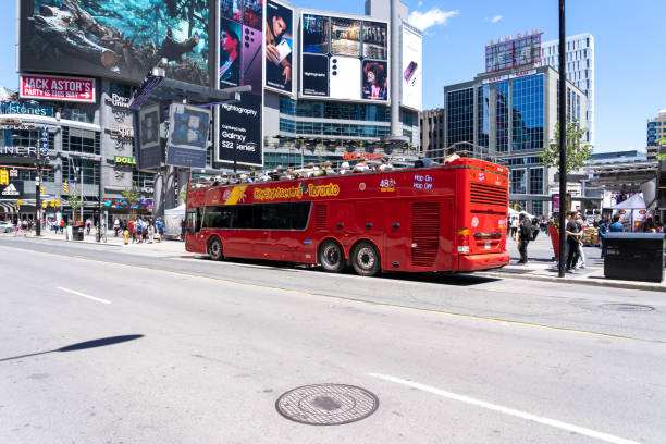 A tour bus at Yonge-Dundas Square in Toronto. Toronto, ON, Canada - June 4, 2022: A tour bus at Yonge-Dundas Square in Toronto. Yonge–Dundas Square, or Dundas Square, is a public square in downtown Toronto. toronto dundas square stock pictures, royalty-free photos & images