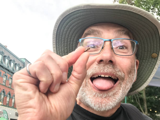 istock Mature man showing a dried cricket 1625893732