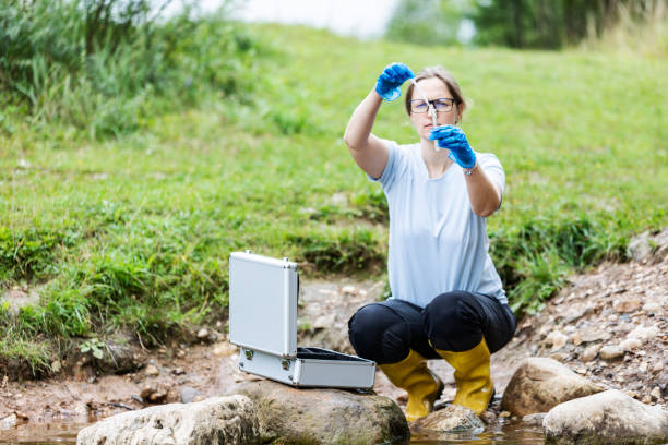 istock Mature woman collected river water sample for analysis 1625967653