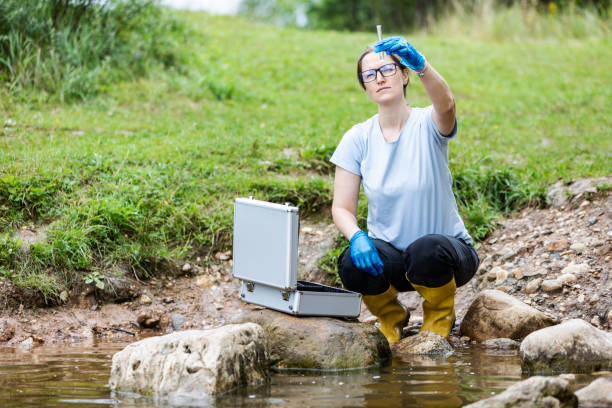 istock Mature woman collected river water sample for analysis 1625975700