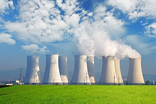 istock Nuclear power plant with yellow field and big blue clouds 162597634