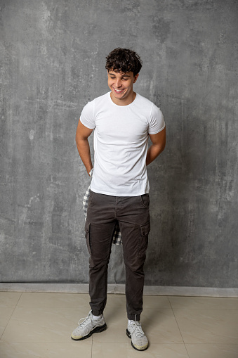 Handsome young man in white t-shirt in studio.