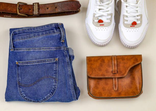istock Brown small bag, jeans, white sneakers and leather belt, flat lay 1626004694