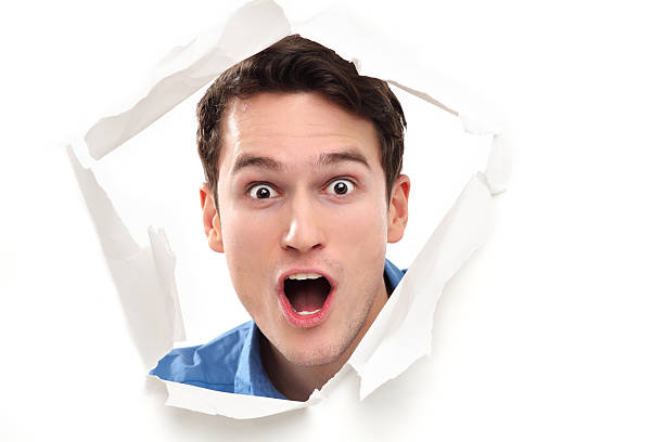 istock Shocked man looking through paper hole 162603707