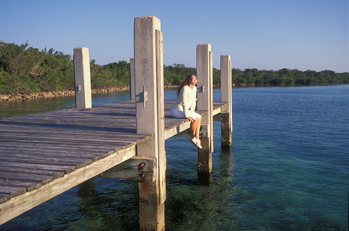 Woman sitting on a pier contemplating the view, Florida Keys, USA