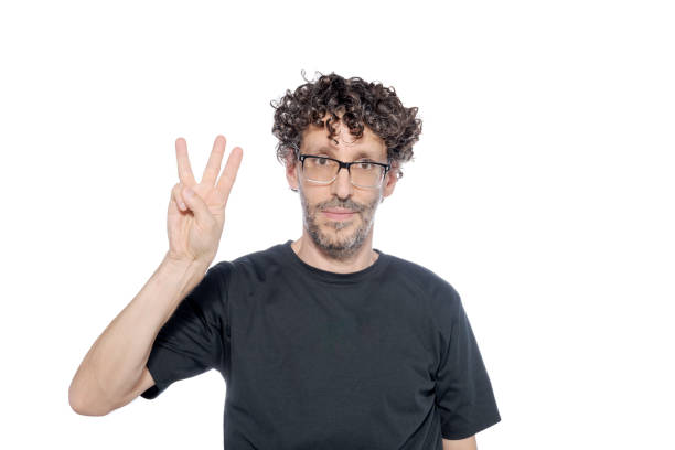 istock Middle-aged man making the number three with his fingers, on white background. 1626067238