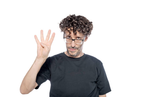 istock Middle-aged man making the number four with his fingers, on white background. 1626067241