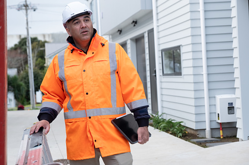 A male construction worker carrying out a site inspection