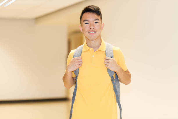 istock Smiling teenage high school student in a corridor 1626112421