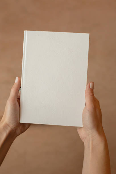 istock She is holding an empty notebook or book. Mockup book. Blank notebook, blank book 1626133309