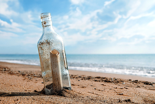 Message in a bottle. The message inside the bottle washed up on the shore