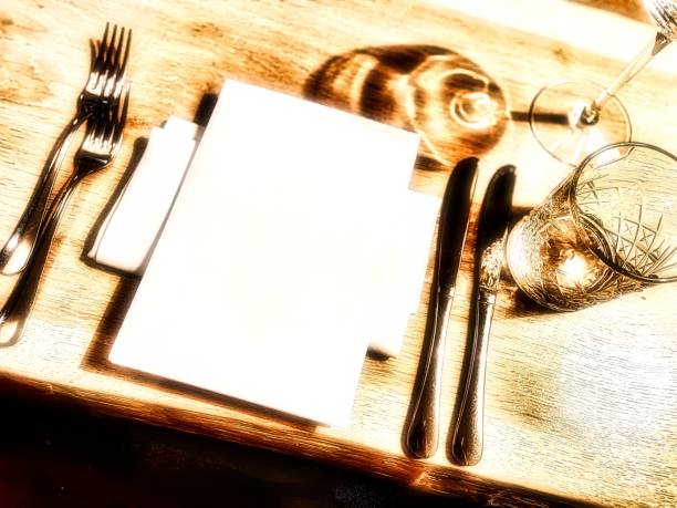 close up luxurious prepared vip table a prepared luxury table with napkins silverware glassware and menu card gala dinner table stock pictures, royalty-free photos & images