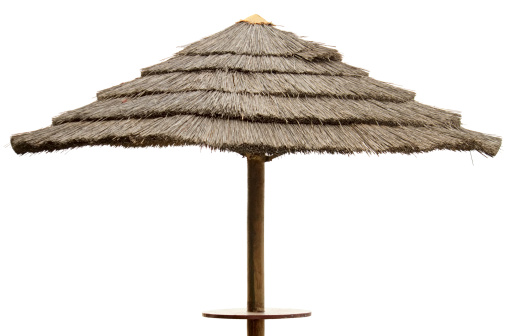 Straw beach umbrella isolated in white