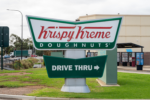 Paralowie, Australia - May 05, 2023: Krispy Kreme store signage at the service station off Port Wakefield Road in Paralowie, South Australia
